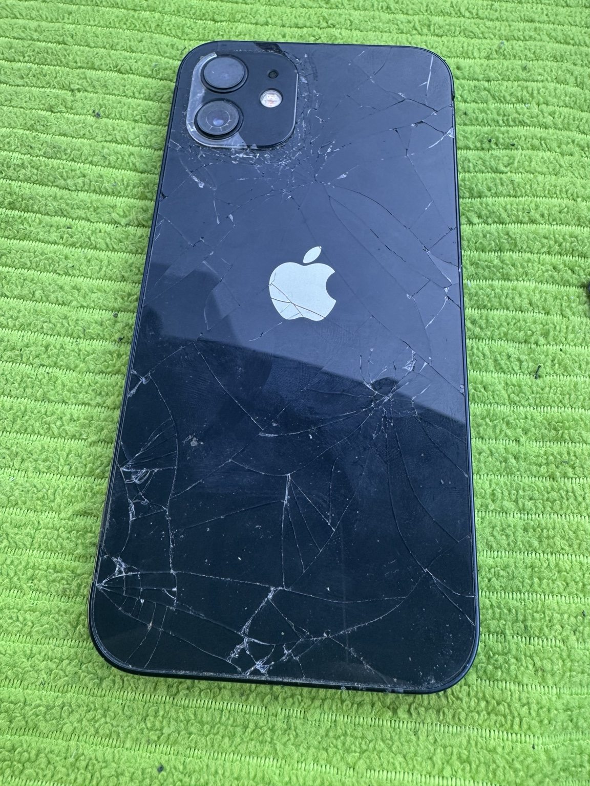 Shattered iPhone 12 rear glass before replacement