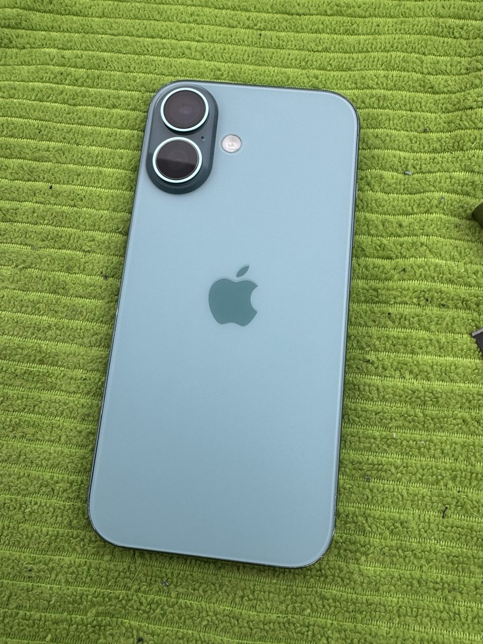 Blue iPhone 16 with new back glass after mobile repair in Erlton SW Calgary