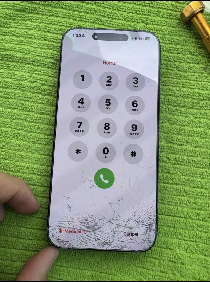 Close-up of cracked iPhone 17 Pro Max screen before replacement at Greenview Industrial Park